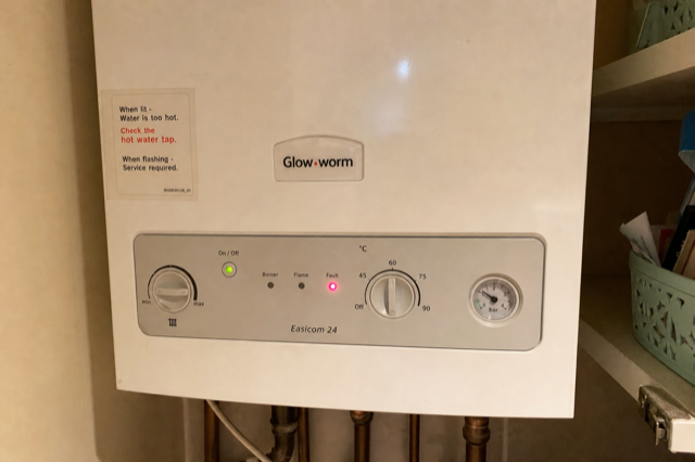 Boiler control panel with a single red indicator light flashing
