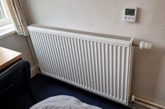 Radiator control valve with no heat output, room thermometer showing 14°C
